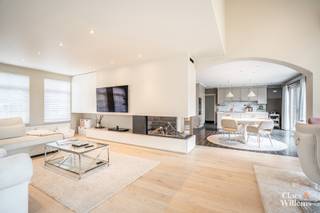 Deze uitzonderlijk ruime villa is rustig gelegen in Itterbeek op een eprceell van +- 19 are, op minder dan 5 minuten van de E40 en met een vlotte verbinding naar Brussel. Dankzij de verhoogde ligging geniet de woning van veel privacy zonder directe inkijk. Bovendien beschikt de villa over een uitstekende energieprestatie met een warmtepomp, centrale verwarming op aardgas, airconditioning, zonnepanelen, een pelletkachel en een gashaard.
Op het gelijkvloers bevinden zich een ruime inkomhal met vestiaire en gastentoilet, een lichtrijke leefruimte met open keuken, een praktische wasplaats met buitendeur, een dubbele garage, een ruime doucheruimte met kleurentherapie en een polyvalente ruimte die kan dienen als slaapkamer, bureau, praktijkruimte of hobbykamer. Dankzij de aparte toegang is deze ruimte ook geschikt voor een vrij beroep of zelfstandige activiteit.
De verdieping omvat een open polyvalente ruimte, een ruime slaapkamer, twee kinderkamers en een mezzanine. Daarnaast beschikt de woning over een afzonderlijke woonvleugel met een tweede leefruimte, een keuken met pelletkachel, een badkamer met bad en douche, een apart toilet, een dressing en een slaapkamer. Deze indeling maakt de woning bijzonder geschikt voor kangoeroewonen, cohousing of inwonende familie.
Op de zolderverdieping bevinden zich een extra mezzanine, momenteel ingericht als fitnessruimte, een zolderruimte en de mogelijkheid om een bijkomende slaapkamer te creëren.
Het terrein is voleldig omheind en afgesloten met een automatische toegangspoort en een afzonderlijk zijpoortje. Er zijn meerdere private parkeerplaatsen, een dubbele garage en een alarmsysteem aanwezig.
De tuin biedt tal van ontspanningsmogelijkheden met een buitenkeuken, een overdekte loungehoek . Daarnaast beschikt het perceel over een afzonderlijk weiland, ideaal voor het houden van dieren.
Troeven
• Rustige ligging nabij E40 en Brussel
• Volledig omheind perceel van ca. 19 are
• Uitstekende energieprestatie
• Warmtepomp, centrale verwarming op aardgas, airconditioning en zonnepanelen
• Pelletkachel en gashaard
• Dubbele garage en meerdere parkeerplaatsen
• Praktijk- of bureauruimte met aparte toegang
• Geschikt voor kangoeroewonen, cohousing of inwonende familie
• Buitenkeuken, jacuzzi en overdekte loungehoek
• Afzonderlijk weiland
• Mogelijkheid tot een bijkomende slaapkamer
Een veelzijdige eigendom met veel woonruimte, privacy en diverse gebruiksmogelijkheden.