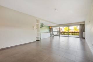 Well-located ground floor apartment with 2 bedrooms and spacious terrace.<br />This attractive apartment is located in the last building of an apartment complex on Kerstraat in Geel.<br />Due to its location, it has a quiet setting and pleasant views of the communal garden.<br />Upon entering, we find a hallway with a guest toilet and coat closet. The hallway provides access to the two bedrooms and the bathroom with a shower and double sink. The spacious living room with open kitchen enjoys plenty of natural light and overlooks the large terrace and communal garden through large sliding windows.<br />The kitchen is equipped with a breakfast nook, generous worktop, sink, dishwasher, ceramic hob with extractor hood, combination oven and fridge, as well as a pantry.<br />A parking space for the car is included and located right next to the apartment.