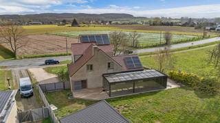 <p>Deze <strong>gerenoveerde/deels nieuwbouw woning</strong> is uitermate geschikt voor grote gezinnen of<strong> gezinnen met praktijkruimte/zelfstandige activiteit</strong>. Dit door verschillende toegangsdeuren. Ook <strong>kangoeroewoning </strong>behoort tot de mogelijkheden. De woning werd volledig gerenoveerd en voorzien van alledaags comfort. Hoewel instap klaar liggen verschillende nutsleidingen al klaar om bijkomende badkamers en bijkomende faciliteiten te bewerkstelligen. Eiken deuren, ingemaakte massieve kasten over de volledige benedenverdieping, massief eiken Amerikaanse keuken met granieten werkblad zijn slechts een deel van de troeven van de woning. De living van maar liefst 50 m² heeft een <strong>adembenemend uitzicht op de achterliggende tuin en velden</strong>. Een <strong>veranda </strong>van 51 m2, met zonnepanelen als dak, zorgt voor een extra leefruimte. De woning bezit <strong>4 slaapkamers</strong> doch de ruimtes die wij beschrijven als bureelruimte (25m²) kan eveneens als bijkomende zelfstandige leefruimte, slaapkamers/praktijkruimte gebruikt worden. Energetisch werd deze woning eveneens aangepakt wat resulteerde in een <strong>EPC A</strong>. <br />Open leefruimtes - Zuinig energetisch verbruik - Mooie locatie op verbindingsweg met achterliggende velden</p>