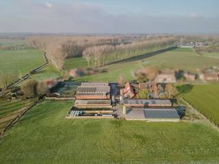 Here you will find a well-maintained villa (built in 2001) with a favourable EPC label B, which indicates an energy-efficient home. The house has a south-facing garden and a large driveway. Next, there is a second, smaller home that currently serves as an office, ideal for professional home use.<br /><br />HOUSE LAYOUT:<br />- spacious entrance hall with separate toilet<br />- fully equipped kitchen<br />- cozy living space with wood stove<br />- pantry/laundry room<br />- master bedroom with adjoining bathroom (washbasin, bath and walk-in shower) and spacious dressing<br />- 2 bedrooms<br />- sauna<br />- indoor garage<br /><br />This is a “green company” (PAS), which makes the economic goals achievable, perfect for young farmers or expansion. The existing stables and permits are suitable for the further exploitation of agriculture. <br /><br />- Permit: environmental permit for 107 cattle and 1064 fattening pigs (current until 2029, NER-D freely fillable)<br />- Stables: two cattle stables and three pigsties. One cattle shed can easily be converted into a pigsty due to the free height of 8 meters.<br />- Quarantine: recently approved type 2 quarantine facility for terrestrial animals<br />- the stables are also ideal for horse boxes with a straw loft (possibility of 9 or more horse boxes)<br /><br />The company is equipped with high-end facilities such as:<br />- Energy: 50 solar panels (with certificates up to 1/11/2030) ensure a low energy bill<br />- Water: own well (22 m) and two large rainwater wells (10,000 l and 15,000 l)<br />- Infrastructure: pavement, two trench silos and a licensed manure trap<br /><br />The property has an extremely good connection to the E40 and E403 motorways (as Aalter-Ruiselede-Tielt). With the necessary permit, this property can also be converted into a residential (permanent) residential function.<br /><br />In short: A unique opportunity for those looking for a business home with storage space, agricultural business or horse accommodation in a prime location!<br /><br />