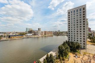 <p><strong>Lichtrijk appartement met zicht op de Schelde aan het Eilandje</strong><br /><br />Op een absolute toplocatie aan het Kattendijkdok, in de gegeerde residentie Westkaai (Toren 5), bevindt zich dit instapklare appartement op de zesde verdieping. Hier woont u op een van de mooiste locaties van Antwerpen, met een prachtig uitzicht op de Schelde, terwijl het bruisende Eilandje, het MAS, gezellige restaurants, winkels en openbaar vervoer zich op wandelafstand bevinden.<span></span></p>
<p>Het appartement, gebouwd in 2016, combineert een moderne architectuur met een kwalitatieve afwerking en een doordachte indeling.</p>
<p>Via de inkomhal met praktische technische berging komt u terecht in de lichtrijke leefruimte, afgewerkt met een warme parketvloer. De grote raampartijen zorgen voor een overvloed aan natuurlijk licht en bieden een prachtig uitzicht op het water. De volledig geïnstalleerde open keuken sluit naadloos aan op de leefruimte en beschikt over alle hedendaagse comfort, inclusief een vaatwasser.</p>
<p>Vanuit zowel de leefruimte als de keuken heeft u toegang tot het zuidgericht, overdekt terras, waar u in alle rust kunt genieten van de zon en het unieke uitzicht over de Schelde.</p>
<p>Via de nachthal bereikt u de ruime slaapkamer, eveneens met een prachtig open zicht. De badkamer is uitgerust met een ligbad met douchesysteem, een wastafel, een handdoekradiator en een aansluiting voor een wasmachine. Daarnaast beschikt het appartement over een afzonderlijk gastentoilet met handenwasser.</p>
<p>Extra opbergruimte vindt u in de privatieve kelderberging op niveau -2. Bovendien is er een gemeenschappelijke fietsenberging aanwezig.</p>
<p>Een ondergrondse autostaanplaats op niveau -1 dient verplicht mee aangekocht te worden aan €35.000.</p>
<strong>Troeven</strong><br /><br />- Gelegen in de prestigieuze residentie Westkaai (Toren 5)<br />- Bouwjaar 2016<br />- Zesde verdieping met prachtig zicht op de Schelde<br />- Zuidgericht overdekt terras<br />- Lichtrijke leefruimte met parket<br />- Kelderberging inbegrepen<br />- Gunstig EPC<br />- Gemeenschappelijke fietsenberging<br />- Ondergrondse parkeerplaats verplicht aan te kopen (€35.000)<br />
<p><br />Een ideale woonst voor wie op zoek is naar een modern appartement met een hoogwaardige afwerking, een uitzonderlijke ligging en een fenomenaal uitzicht aan het Eilandje.</p>
<p>Interesse? Contacteer Xander via 0497 18 10 84 of xander@reds.be voor meer informatie of een bezoek ter plaatse.</p>