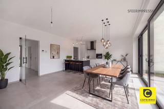 <p><span>Energiezuinig gelijkvloers appartement met terras en gemeenschappelijke tuin </span></p><p><span>Welkom in dit energiezuinige gelijkvloerse appartement, gelegen in een recent gebouwd appartementsgebouw aan de Schuurveldlaan. Hier geniet u van modern wooncomfort, een uitstekende label A en een aangename combinatie van binnen- en buitenruimte. Dankzij de energiezuinige technieken zoals de vloerverwarming, ventilatiesysteem type C+ én de aanwezige zonnepanelen, woont u hier niet alleen comfortabel maar ook bijzonder energie-efficiënt en toekomstgericht.</span></p><h2><span>Ligging</span></h2><p><span>Dit appartement heeft een zeer gunstige en strategische ligging aan de Schuurveldlaan, in de nabijheid van zowel het dorpscentrum van Wilrijk als Aartselaar. Daarnaast geniet u van een uitstekende verbinding naar de belangrijkste invalswegen richting Antwerpen en Brussel, wat deze locatie bijzonder interessant maakt voor pendelaars. U woont hier in een rustige woonomgeving met toch alle voorzieningen zoals winkels, scholen, horeca en openbaar vervoer binnen handbereik.</span></p><h2><span>Indeling</span></h2><p><span>Via de inkomhal, afgewerkt met een stijlvolle grijze tegelvloer, komt u meteen in een lichtrijke en aangename sfeer terecht. De inkomhal geeft toegang tot de verschillende ruimtes en leidt u verder naar de ruime leefruimte met open eilandkeuken.</span></p><p><span>De leefruimte geniet van uitzonderlijk veel natuurlijk licht dankzij de hoogrendements aluminium raampartijen over de volledige breedte. Deze bieden bovendien een mooi zicht op het privatieve terras en de gemeenschappelijke tuin. Twee ramen zijn voorzien van vliegenramen voor extra comfort. Via de schuifdeur bereikt u het privatieve terras van ca. 14 m², waar het heerlijk vertoeven is. De aanpalende gemeenschappelijke tuin voelt dankzij de beschutting quasi privatief aan en biedt een rustige groene omgeving om te ontspannen of gasten te ontvangen.</span></p><p><span>De open eilandkeuken is modern en hoogwaardig afgewerkt met onder meer een composiet werkblad en beschikt over alle hedendaagse toestellen: vaatwasser, oven, inductiekookplaat, koelkast, diepvries en voldoende kastruimte. Aansluitend bevindt zich een praktische berging met extra stockageruimte.</span></p><p><span>Verder bevindt zich links van de inkomhal de ruime slaapkamer, met voldoende plaats voor een dubbel bed en kastruimte. De badkamer is modern afgewerkt en voorzien van een inloopdouche, lavabo en handdoekradiator. Daarnaast is er nog een aparte technische ruimte met aansluiting voor wasmachine en droogkast.</span></p><p><span>In de ondergrondse verdieping beschikt u over een zeer ruime kelderberging, bereikbaar via lift of trap. Tevens is er een gemeenschappelijke fietsenberging aanwezig. De ondergrondse autostaanplaats dient verplicht mee aangekocht te worden voor een vraagprijs van 20.000 euro</span></p><p><span>Een extra troef is dat de aankoop kan gebeuren onder registratierechten (2%) in plaats van btw, wat financieel zeer interessant is.</span></p><h2><span>Troeven</span></h2><ul><li><span>Energiezuinig appartement met label A </span></li><li><span>Zonnepanelen aanwezig </span></li><li><span>Vloerverwarming </span></li><li><span>Ventilatiesysteem type C+ </span></li><li><span>Recent bouwjaar </span></li><li><span>Privatief terras en gemeenschappelijke tuin met quasi privatief gevoel </span></li><li><span>Zeer ruime kelderberging </span></li><li><span>Gemeenschappelijke fietsenberging </span></li></ul><p><span> </span></p><p><span>Dit appartement combineert comfort, luxe en een uitzonderlijk buitengevoel op een toplocatie in Wilrijk.</span></p><p><span> </span></p>